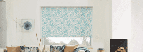 Living room with patterned motorised roller blinds with large blue specks