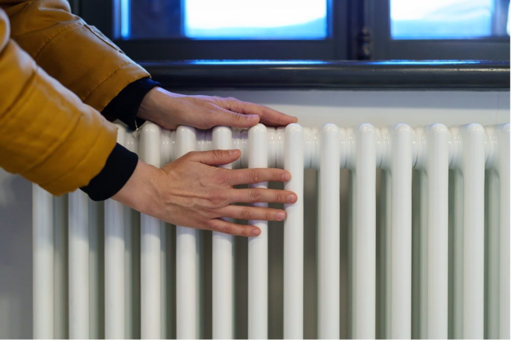 How to Reduce Energy Costs - Warming Hands on Heater