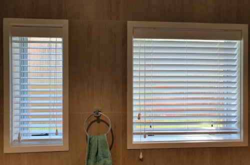 Home Vision Blinds clients bathroom with shutter blinds on two windows for stylish privacy, and alternative option to roller blinds Auckland.